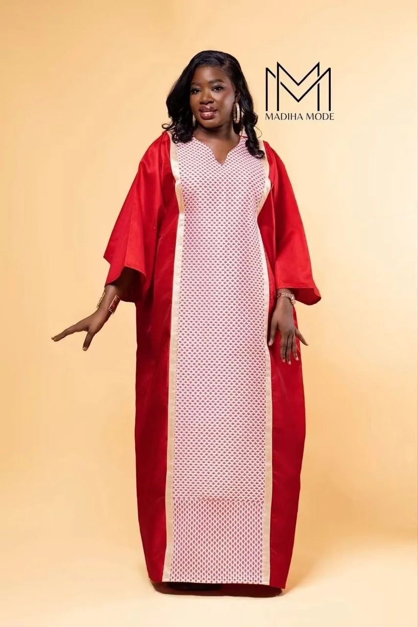 Boubou rouge au plastron ajouré sur fond beige
